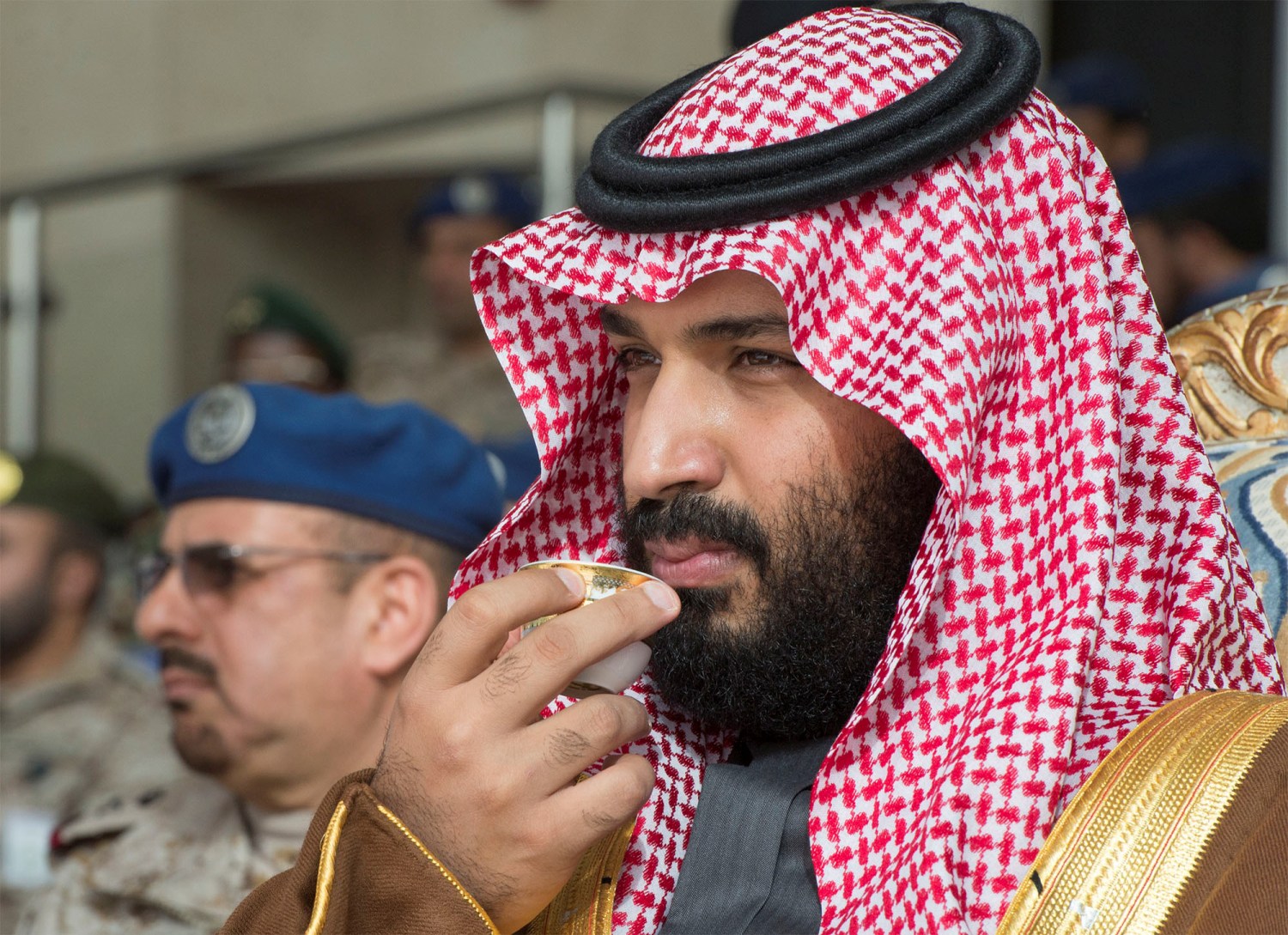 Saudi Arabia's Crown Prince Mohammed bin Salman drinks coffee during the graduation ceremony of the 93rd batch of the cadets of King Faisal Air Academy, in Riyadh, Saudi Arabia, February 21, 2018. Bandar Algaloud/Courtesy of Saudi Royal Court/Handout via REUTERS ATTENTION EDITORS - THIS PICTURE WAS PROVIDED BY A THIRD PARTY. - RC1640D13C90