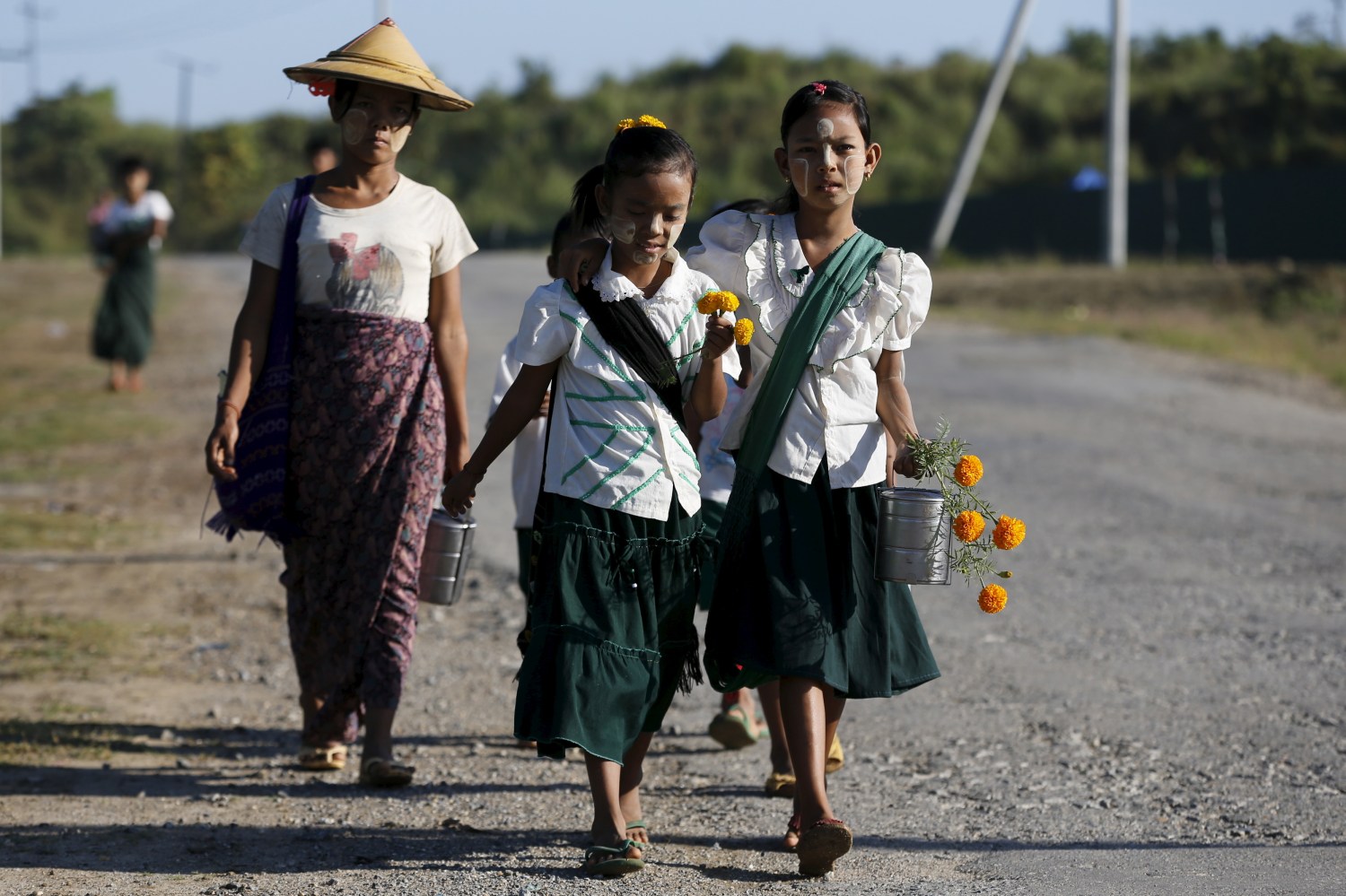 Girls walk to school at the outskirts of Yangon