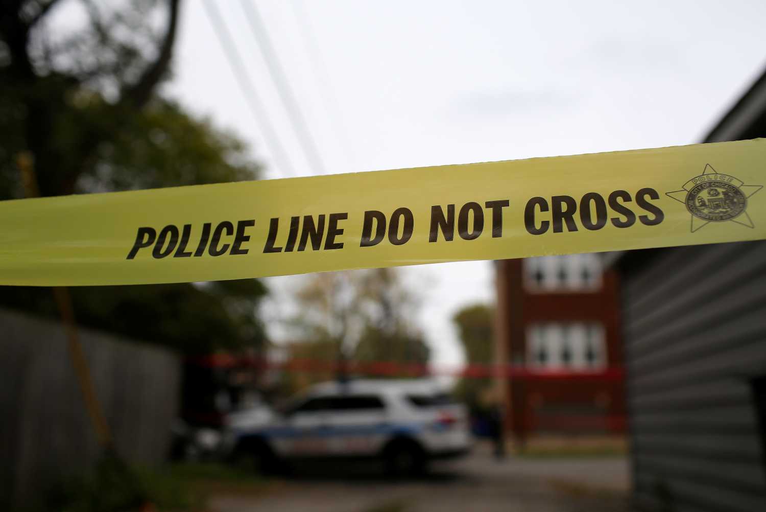 Yellow police tape is displayed at a crime scene after a motorist was shot in the head in Chicago
