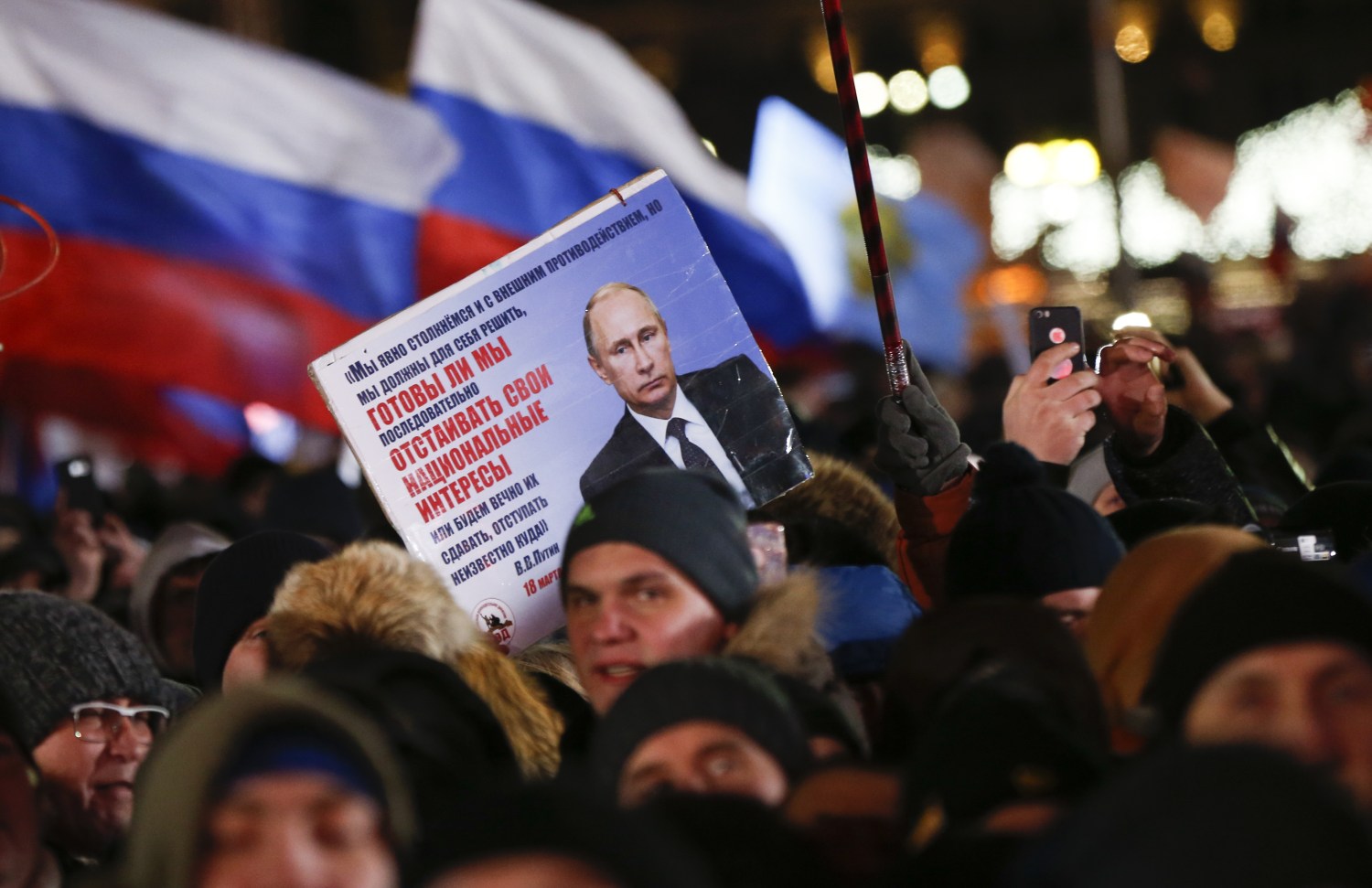 People attend a rally and concert marking the fourth anniversary of Russia's annexation of the Crimea region, at Manezhnaya Square in central Moscow