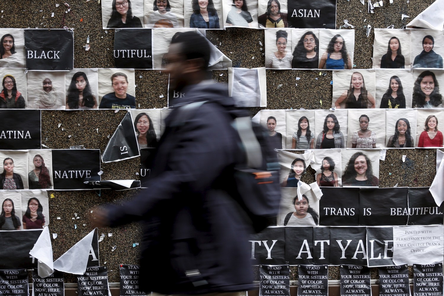 A student walks by a college notice board on campus at Yale University where more than 1,000 students, professors and staff at gathered to discuss race and diversity.