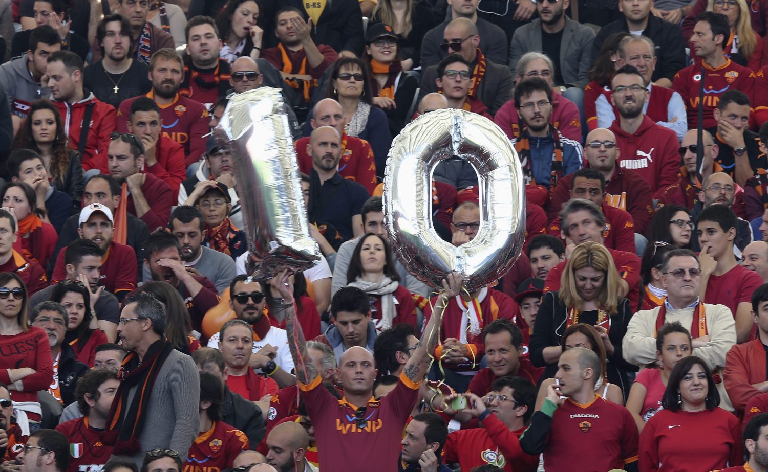 An soccer fan holds a number 10 before the Italian Cup final soccer match.