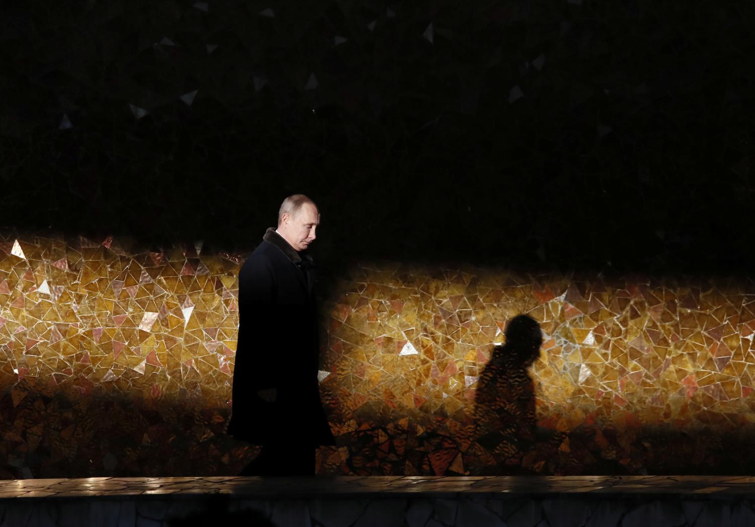 Russian President Putin attends a wreath laying ceremony at the eternal flame during an event to commemorate the 75th anniversary of the battle of Stalingrad in World War Two, at the Mamayev Kurgan memorial complex in Volgograd