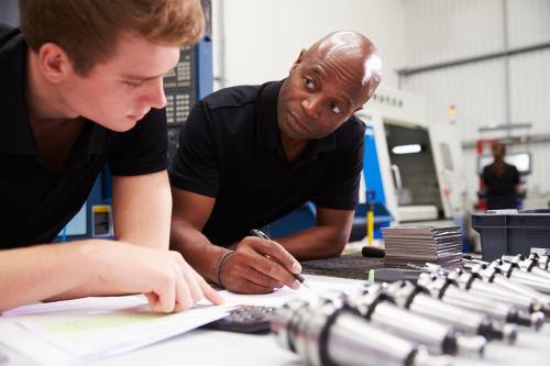 Engineer And Apprentice Planning CNC Machinery Project