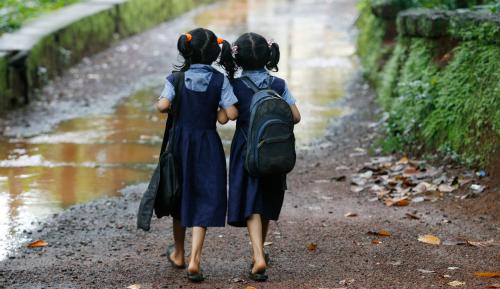 Twin girls walk to their school in Kodinji village in the southern Indian city of Kerala
