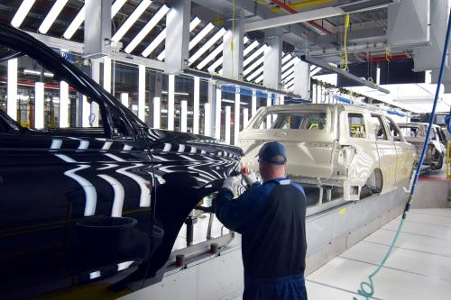 A Ford worker inspects paint work on the body of a Ford Expedition SUV at Ford's Kentucky Truck Plant in Louisville, Kentucky.