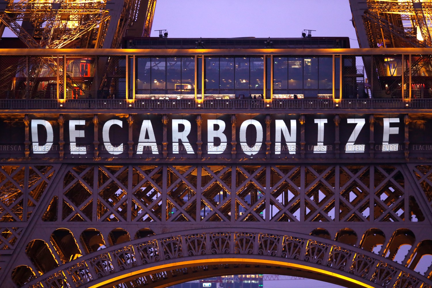 Photo: The slogan "Decarbonize" is projected on the Eiffel Tower as part of the World Climate Change Conference 2015 (COP21) in Paris, France, December 11, 2015. REUTERS/Charles Platiau - LR1EBCB1BVQ2S