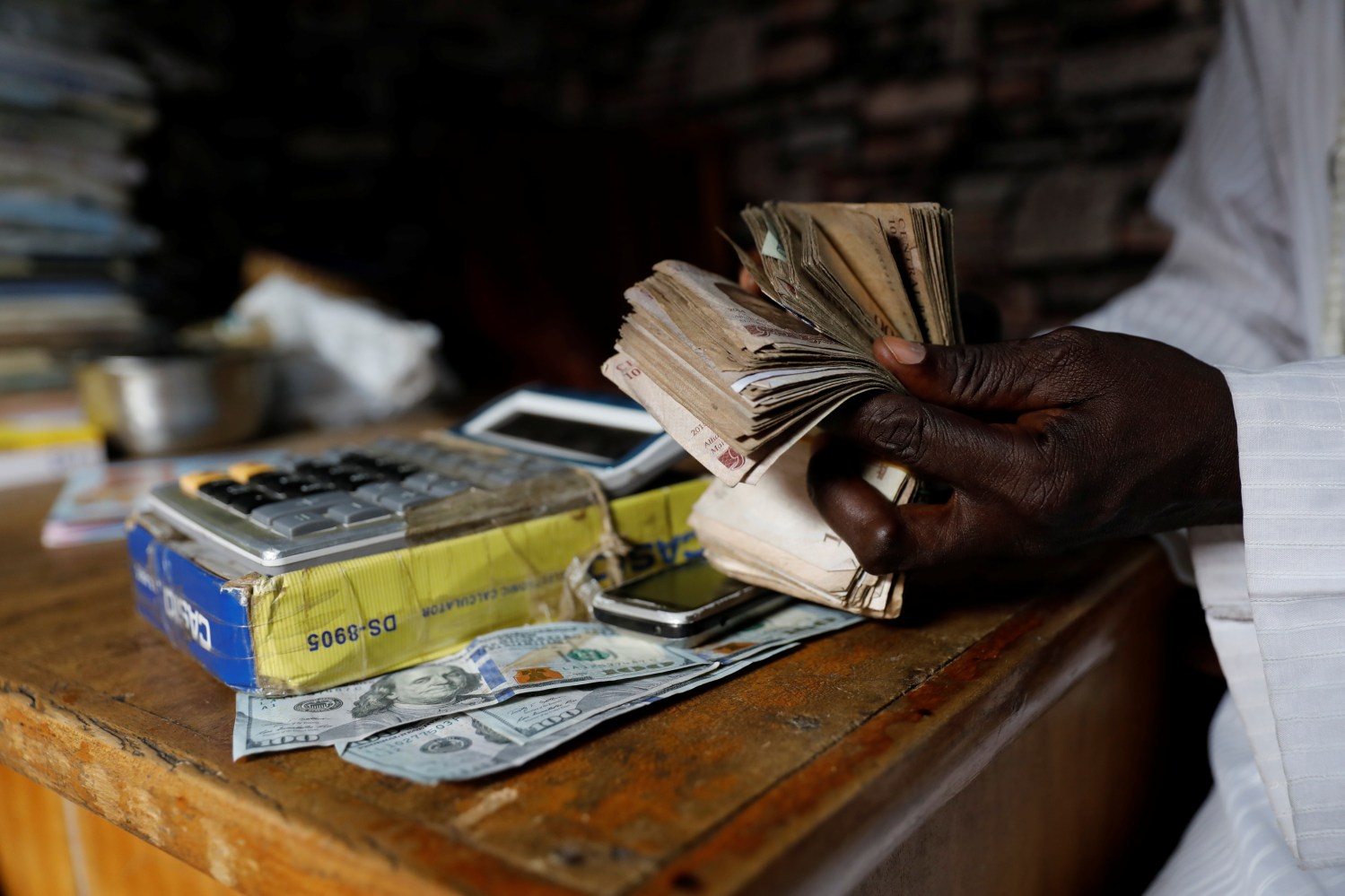 A man counts the Nigerian naira at a currency exchange market in Ikeja district in Lagos.