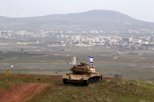 An old military vehicle can be seen positioned on the Israeli side of the border with Syria, near the Druze village of Majdal Shams in the Israeli-occupied Golan Heights, Israel February 11, 2018. REUTERS/Ammar Awad - RC1E11DB8E30