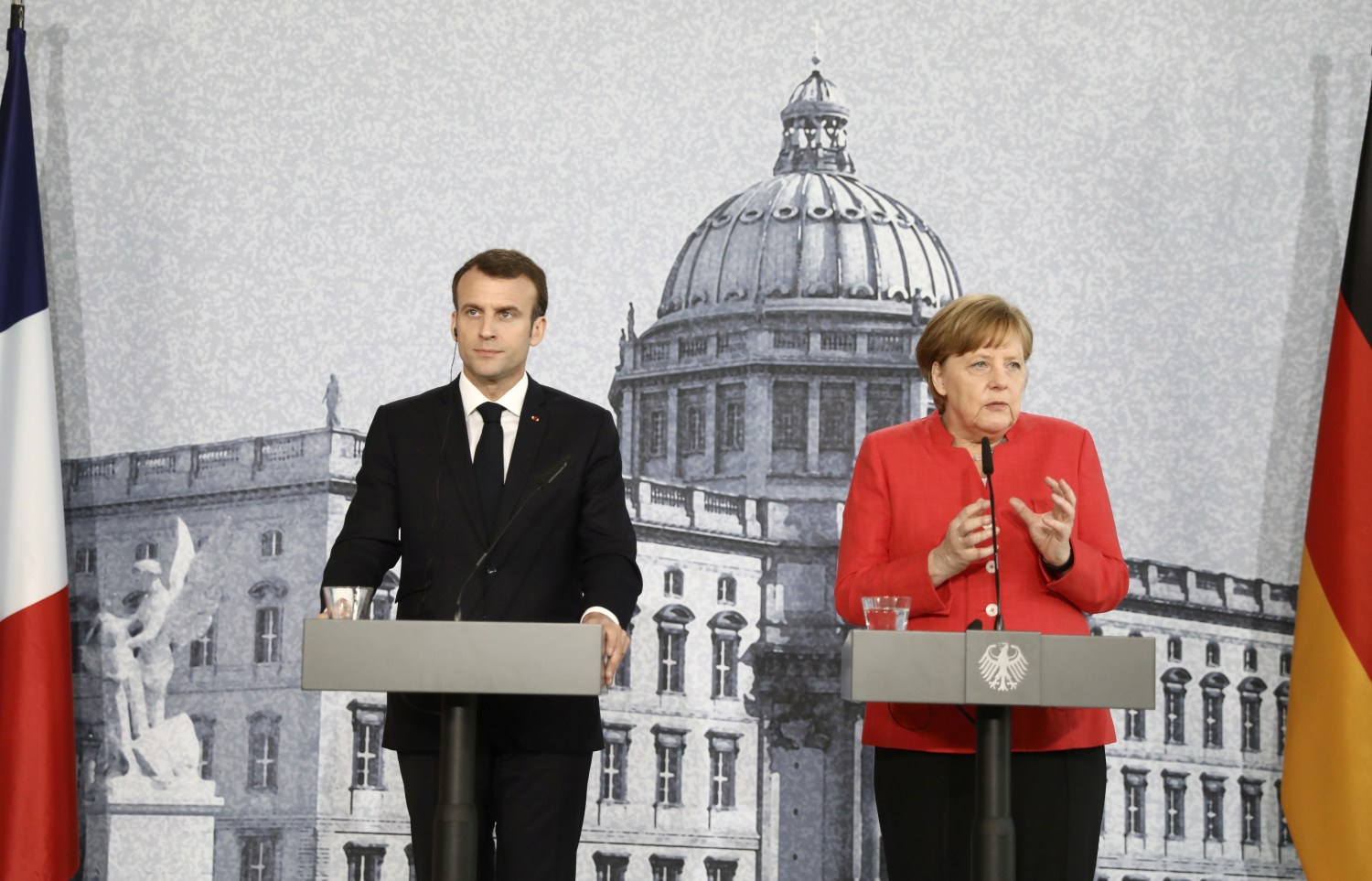 German Chancellor Angela Merkel and French President Emmanuel Macron hold a news conference at the building site of the Humboldt Forum in Berlin, Germany, April 19, 2018. Kay Nietfeld/Pool via Reuters - RC1A6FA5ADC0