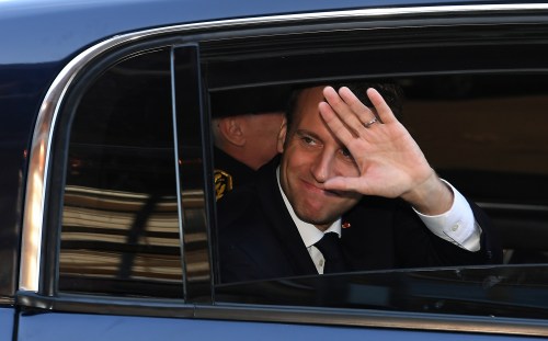 French President Emmanuel Macron waves from his car as he leaves after a visit about local and organic food supply in school canteens, at the secondary school Guy Dolmaire in Mirecourt, France, April 19, 2018. Patrick Hertzog/Pool via Reuters - RC148066A640
