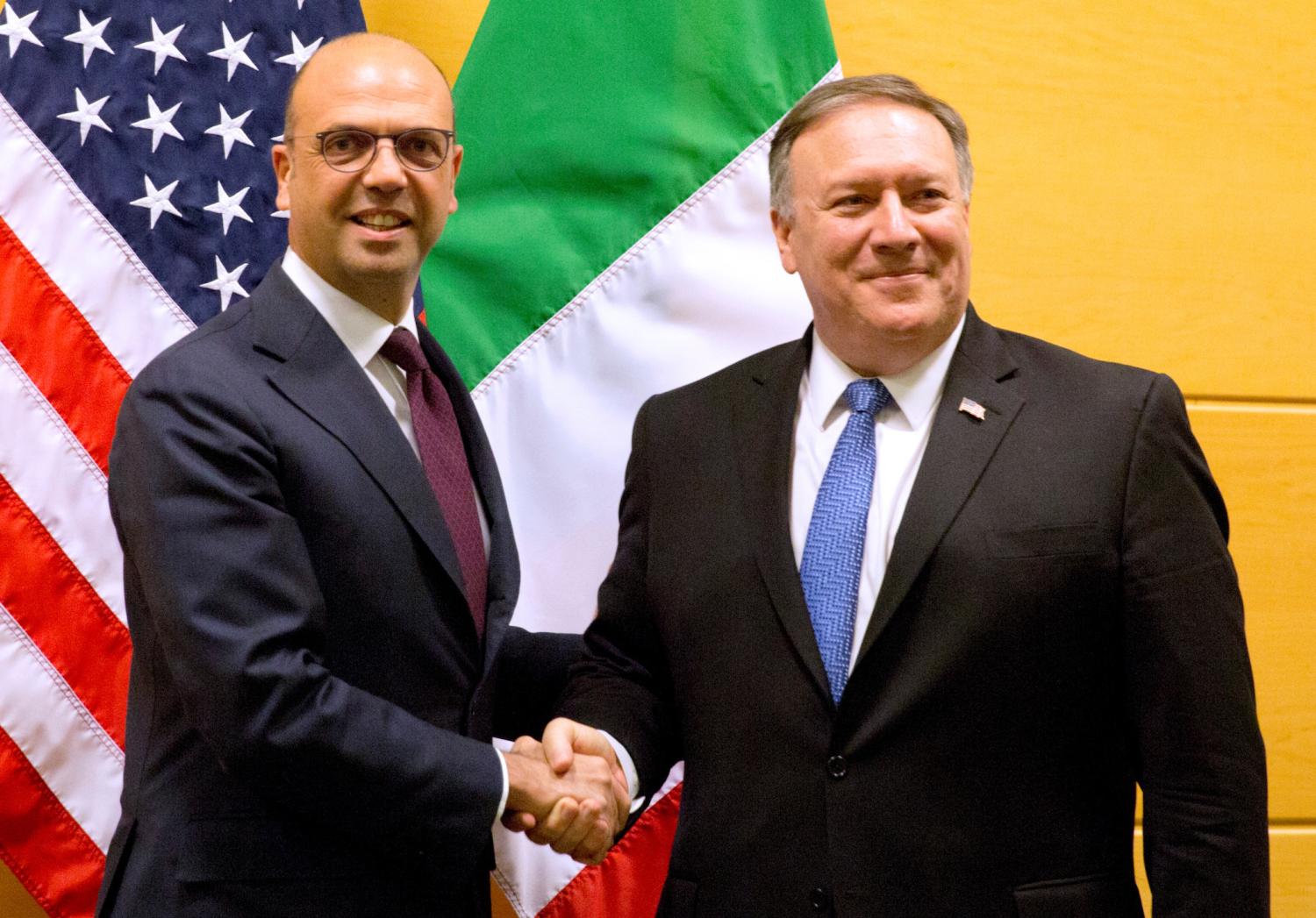 U.S. Secretary of State Mike Pompeo greets Italian Foreign Minister Angelino Alfano during a NATO foreign ministers meeting at the Alliance's headquarters in Brussels, Belgium April 27, 2018. Virginia Mayo/Pool via Reuters - RC1D17AC24E0