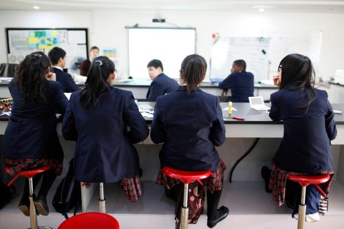 Private school students listen during lecture.