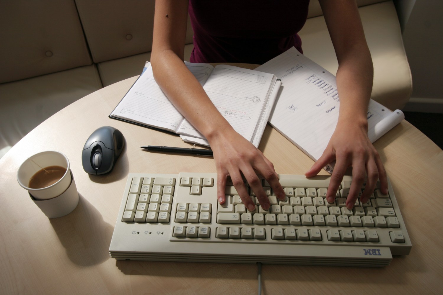 woman working in an office sitting at her desk typing