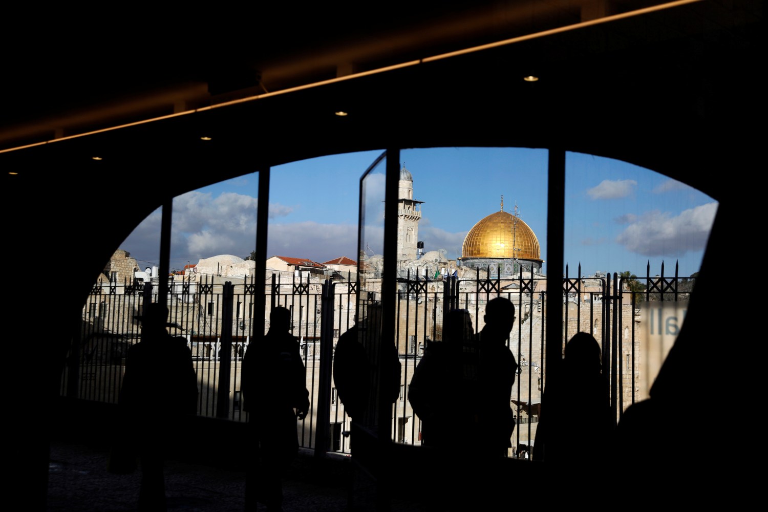 People look out from a building facing the Dome of the Rock (R), located in Jerusalem's Old City on the compound known to Muslims as Noble Sanctuary and to Jews as Temple Mount December 7, 2017. REUTERS/Ronen Zvulun - RC18733A13D0