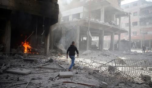 A man walks on rubble at a damaged site after an airstrike in the besieged town of Douma, Eastern Ghouta, Damascus, Syria February 9, 2018. REUTERS/Bassam Khabieh - RC18866F2CF0