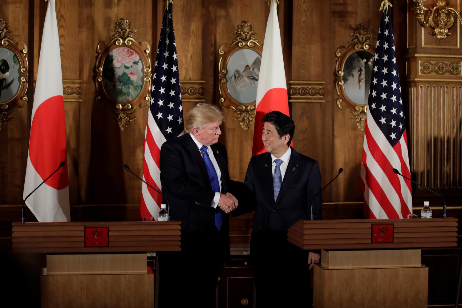 U.S. President Donald Trump, left, shakes hands with Shinzo Abe, Japan's prime minister, during a news conference at Akasaka Palace in Tokyo, Japan, November 6, 2017. REUTERS/Kiyoshi Ota/Pool - RC1C9C826580