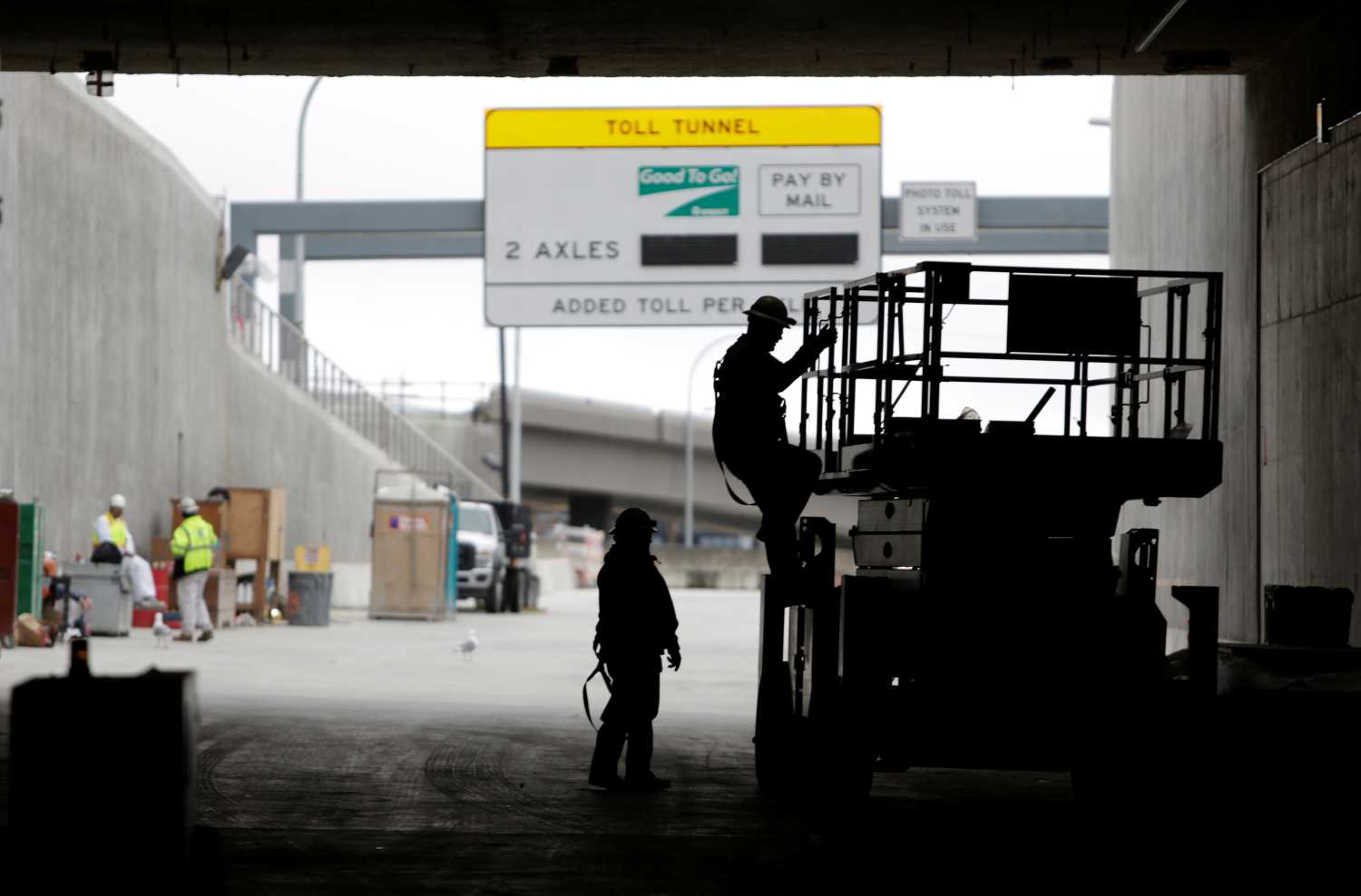 Workers are pictured, near the exit of the southbound lanes of the double deck State Route 99 highway tunnel, under construction in Seattle, Washington, U.S., March 27, 2018. REUTERS/Jason Redmond - RC1D90DA79D0