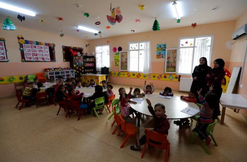 Syrian refugee children attend a class at a refugee camp in Nizip in Gaziantep province, near the Turkish-Syrian border March 17, 2014. Aleppo continues to bear the brunt of the civil war, in which about 140,000 people have died. Almost two years after rebels grabbed half of the city, they are now on the defensive, with government forces advancing on three sides. Turkey began building its refugee camps near the border in mid-2011, little knowing the war would last so long and bring such vast numbers of people, many of them women and children. More than 220,000 Syrians are living in the Turkish camps, but some three times that number struggle to exist outside them. Some try and eke out an existence around southeast Turkey, the country's poorest region. Picture taken March 17, 2014. To match SYRIA-REFUGEES/ REUTERS/Murad Sezer (TURKEY - Tags: POLITICS SOCIETY EDUCATION) - GM1EA3Q1I9G01