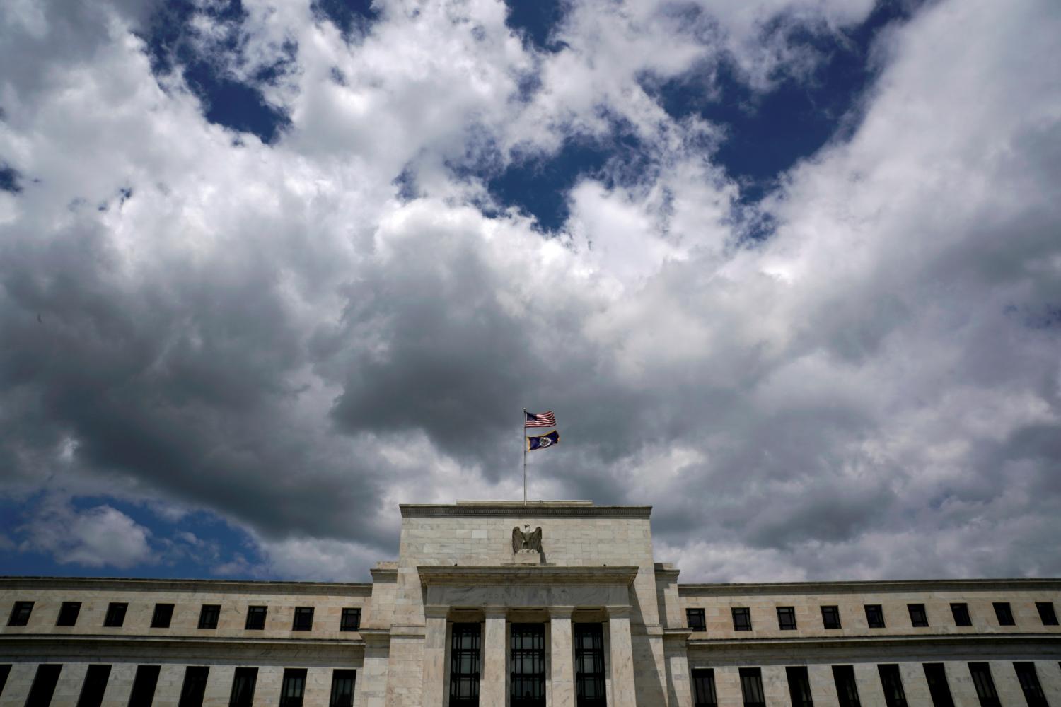 Flags fly over the Federal Reserve Headquarters on a windy day in Washington, U.S., May 26, 2017. REUTERS/Kevin Lamarque - RC1E2991B8B0