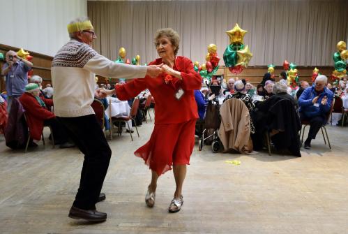 Anita Monk and her neighbour John Everett dance during a Christmas Dinner event for older people at Hammersmith and Fulham Town Hall in London, Britain December 25, 2016. REUTERS/Kevin Coombs - RC18585124A0
