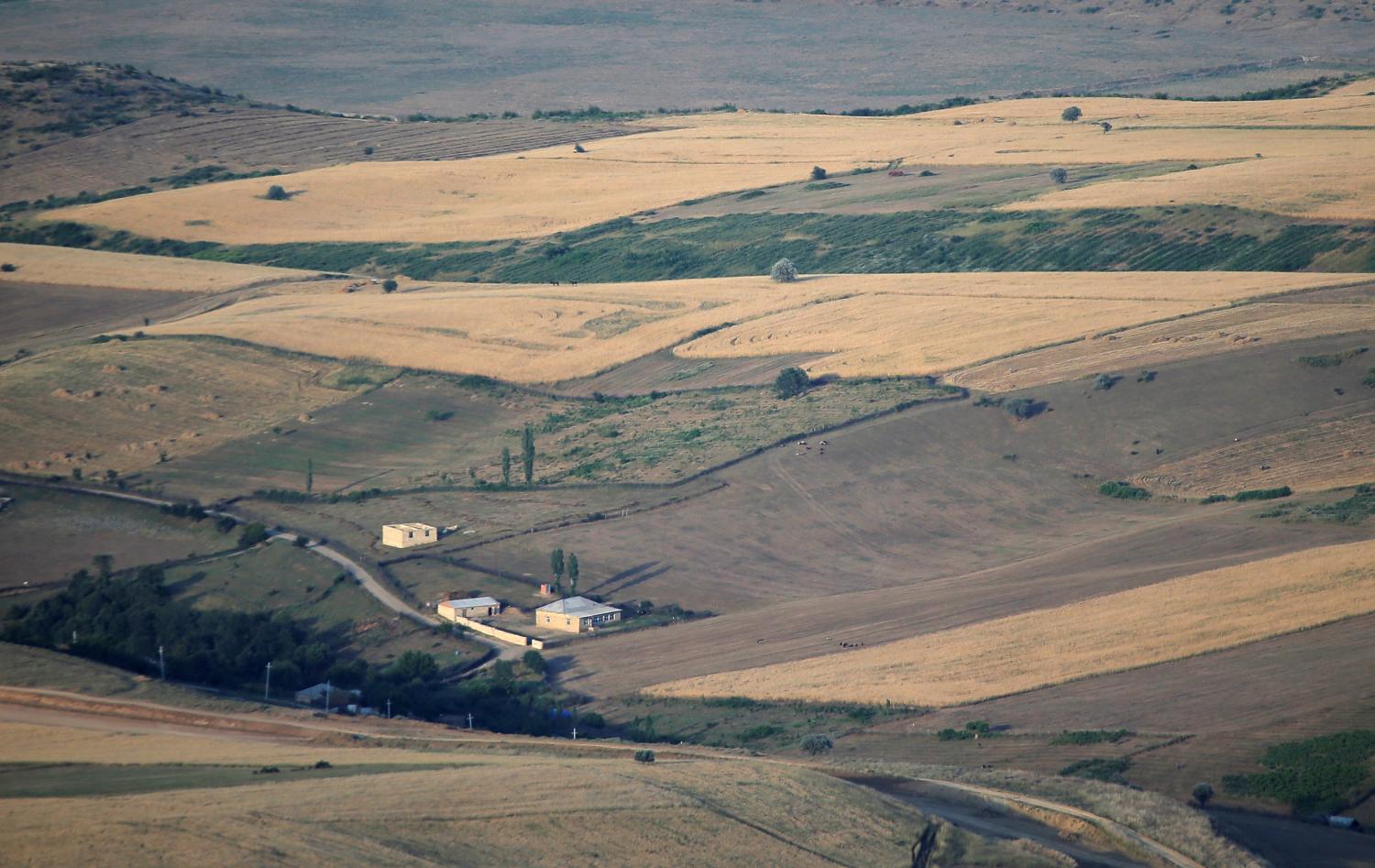 A general view shows houses surrounded by fields outside the village of Qalaalti, Azerbaijan, June 20, 2016. REUTERS/Maxim Shemetov - D1AETMNKFCAB