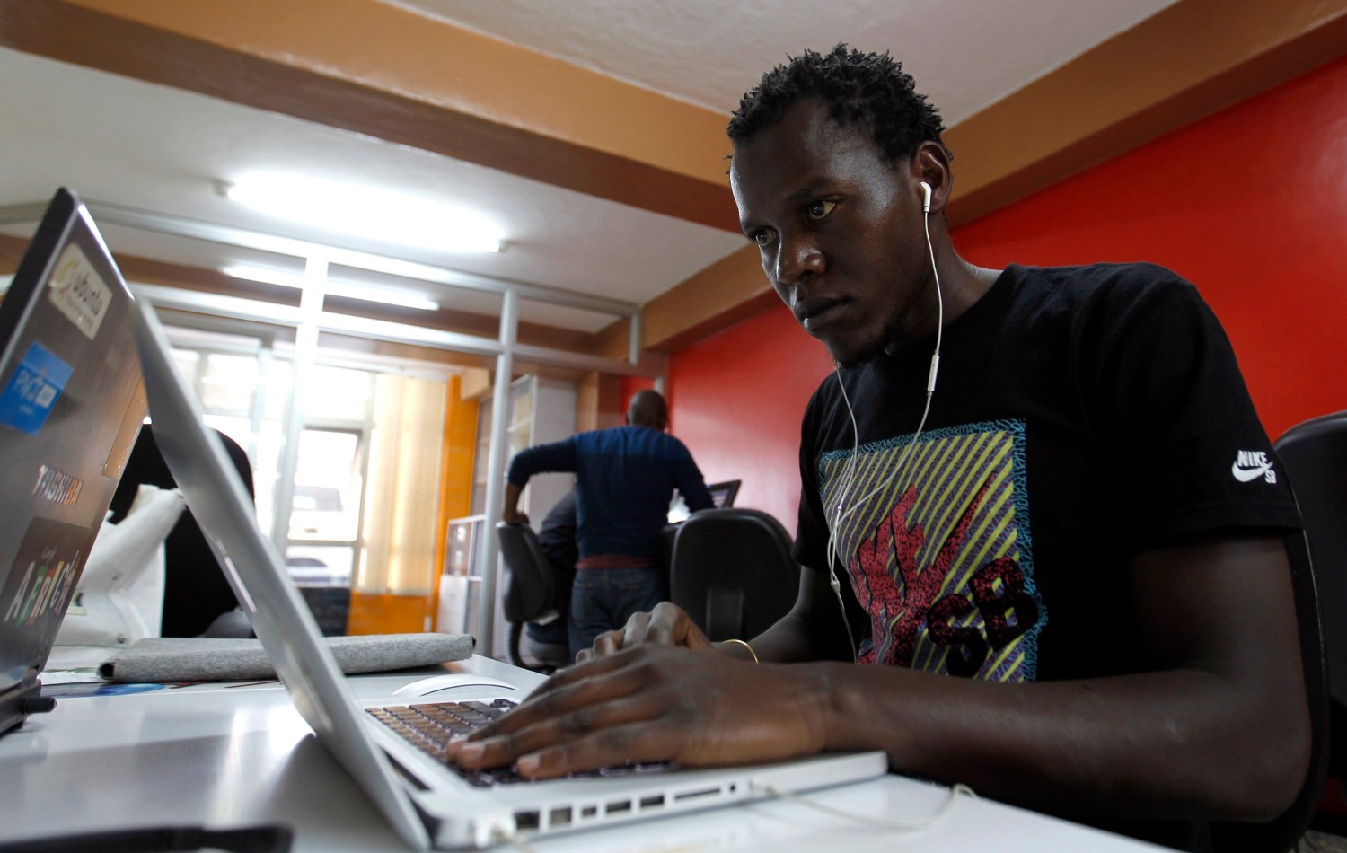Duncan Onyango, a game design developer at Planet Rackus works on MA3Racer, a 2D mobile game inside his studio in Kenya's capital Nairobi, July 15, 2014. Industry analysts have long hailed the explosive growth of mobile telecoms in sub-Saharan Africa - 635 million subscribers by the end of 2014 climbing to 930 million by the end of 2019 according to a report by Ericsson. But size isn't everything. It is the quality of those mobile phone connections, subscriptions and surrounding infrastructure that is holding up Africa's nascent games development industry, not the quantity of handsets. The number of expensive smartphones that can run sophisticated games and applications is low, accounting for only 14 percent of African mobile connections by the end of 2014, says research group Ovum. Planet Rackus's first edition of MA3Racer, a 2D mobile game, had more than a million downloads on Nokia's Ovi platform, reflecting strong demand.  REUTERS/Thomas Mukoya (KENYA - Tags: SOCIETY SCIENCE TECHNOLOGY BUSINESS TELECOMS) - GM1EA7F1HRG01