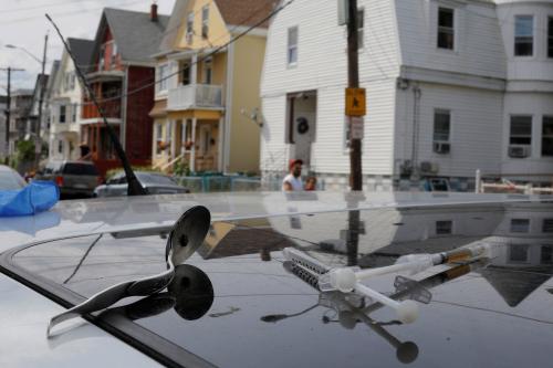 A syringe filled a narcotic, an empty syringe and a spoon sit on the roof of a car, where a man in his 20's overdosed on opioids in Lynn, Massachusetts, U.S., August 14, 2017. Picture taken August 14, 2017. REUTERS/Brian Snyder - RC1257D38130