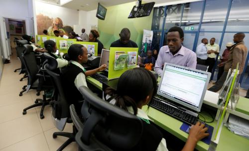 Employees serve customers inside a mobile phone care centre operated by Kenyan's telecom operator Safaricom in the central business district of Kenya's capital Nairobi, May 11, 2016. REUTERS/Thomas Mukoya - D1AETDLLWWAA