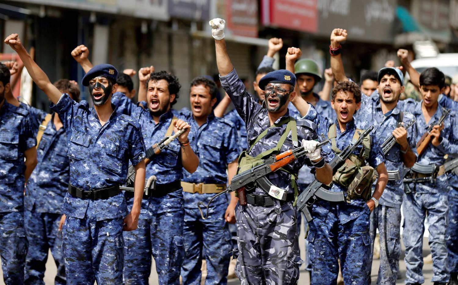 Members of a security force loyal to the Houthi rebels take part in a military parade at the Tahrir Square in downtown Sanaa, Yemen July 19, 2017. The placard reads: "Allah is the greatest. Death to America, death to Israel, a curse on the Jews, victory to Islam". REUTERS/Khaled Abdullah - RC1C3C220F90