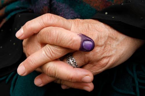 The ink-stained finger of an Iraqi woman living in Jordan is seen as she waits after casting her ballot at a polling station.