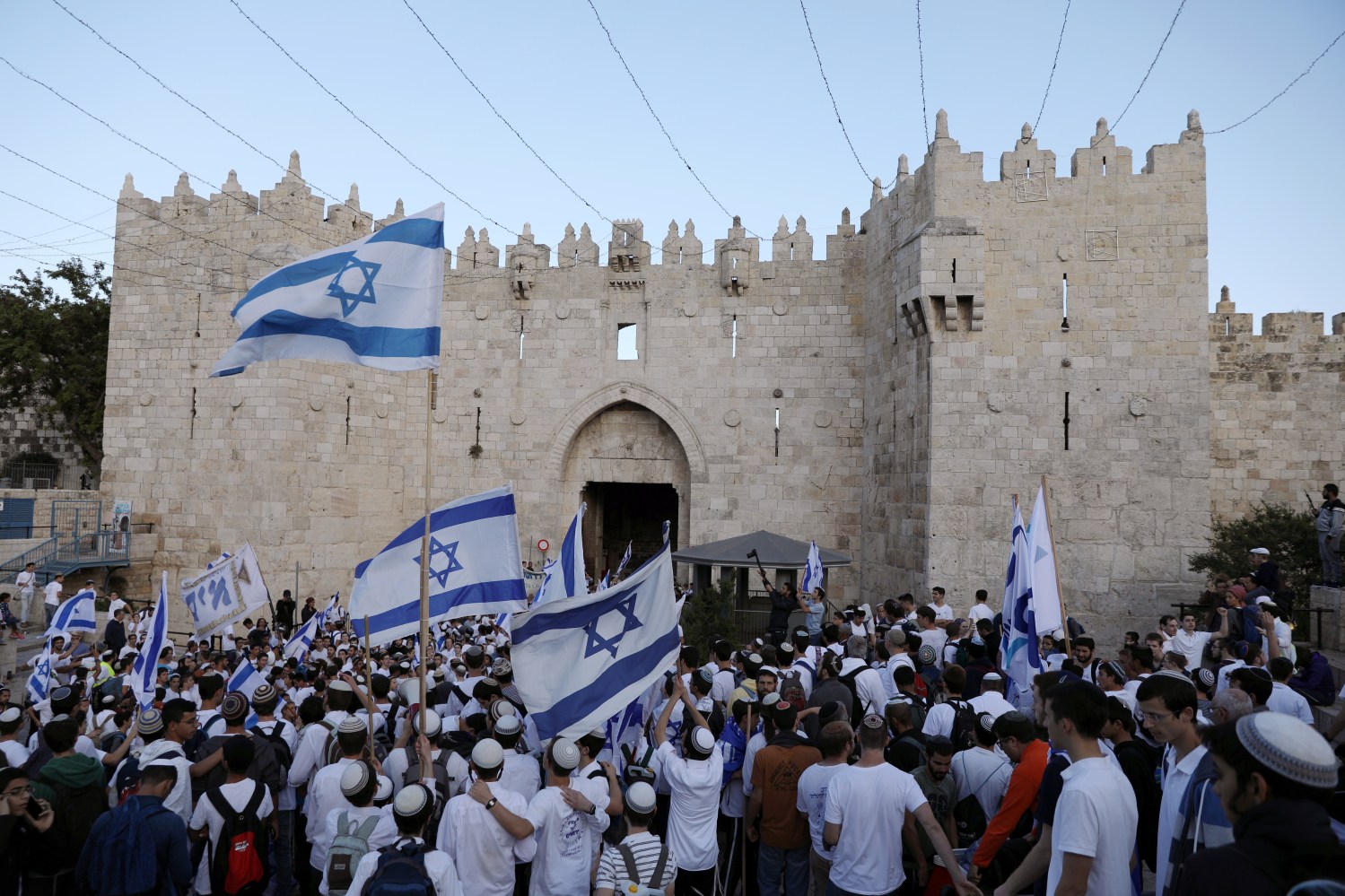Israelis celebrate as they hold Israeli flags during a parade marking the annual Jerusalem Day, at Damascus Gate in Jerusalem's Old City, May 13, 2018. REUTERS/Ammar Awad - RC1A6A0D5F10