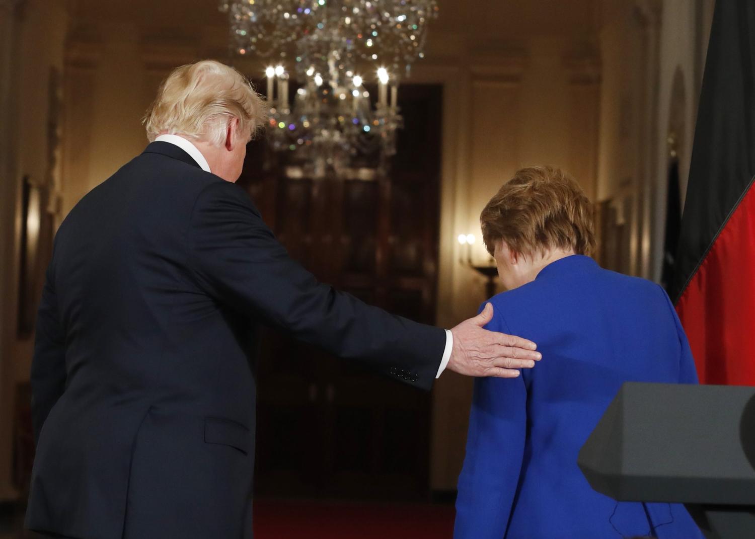 U.S. President Donald Trump and Germany's Chancellor Angela Merkel depart after a joint news conference in the East Room of the White House in Washington, U.S., April 27, 2018. REUTERS/Kevin Lamarque - HP1EE4R1GG1H3