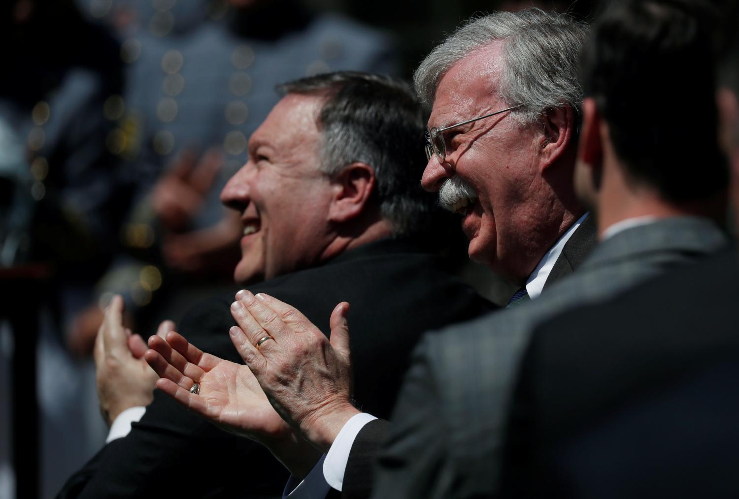 U.S. Secretary of State Mike Pompeo and National Security Advisor John Bolton applaud as President Donald Trump presents the Commander-in-Chief's Trophy to the U.S. Military Academy football team in the Rose Garden at the White House in Washington, U.S., May 1, 2018. REUTERS/Leah Millis - RC1DAD60CB00