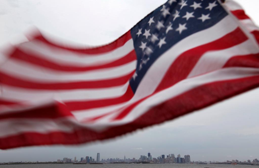 A U.S. flag flutters over top of the skyline of New York (R) and Jersey City (L), as seen from Bayonne, New Jersey, August 6, 2011. New York will mark the 10th anniversary of the attack on the World Trade Center with ceremonies on September 11. REUTERS/Gary Hershorn (UNITED STATES - Tags: CITYSCAPE DISASTER IMAGES OF THE DAY) - GM1E7870MYD01