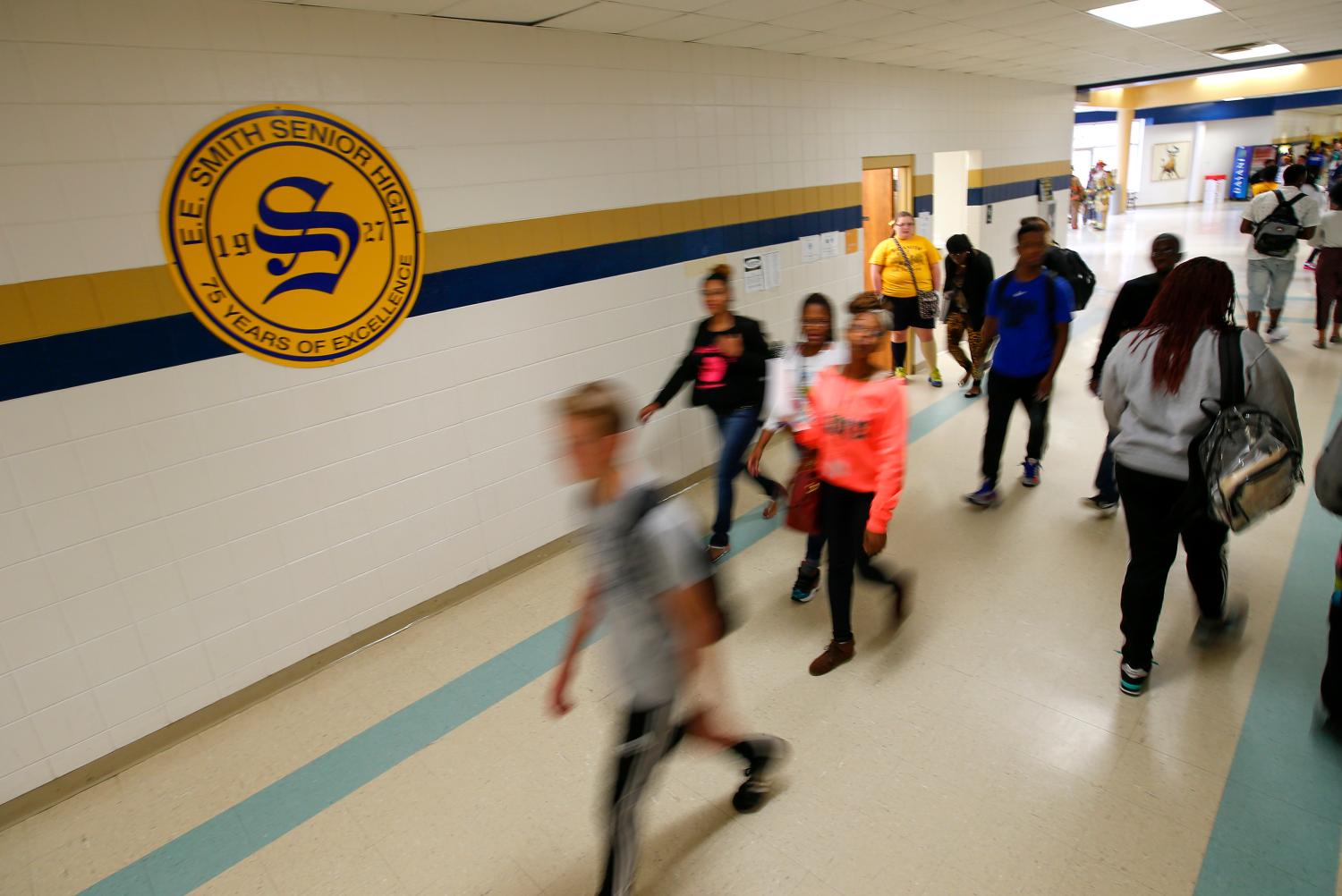 Students walk through the hallway during a class change at E.E. Smith High School.