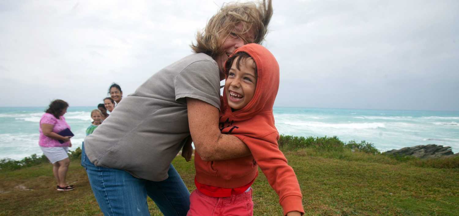 People stand an island's southern shore.