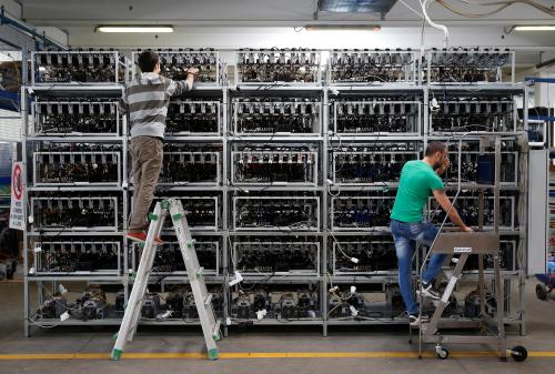 Employees work on bitcoin mining computers at Bitminer Factory in Florence, Italy, April 6, 2018. Picture taken April 6, 2018. REUTERS/Alessandro Bianchi - RC1154C44E80