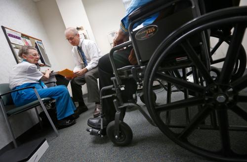 Doctor Stephen Hippler speaks to patients Don and Ruthie Roth at his office in Peoria, Illinois, November 26, 2013. Now, patients are at the forefront of an experiment, under way in Peoria, Illinois, and hundreds of other U.S. cities, that could transform the way doctors, nurses and hospitals deliver care to patients. Amid the barrage of criticism over the rollout of Obamacare, groups known as Accountable Care Organizations (ACOs) are quietly going about the business of testing the potential for healthcare reform. The efforts, born of President Barack Obama's Affordable Care Act, are part of the biggest experiment yet to fix the costly and error-plagued U.S. healthcare system. The new models of care, which encourage providers to form networks to coordinate care and cut costs, involve close monitoring of the sickest patients to address budding health problems before they cause a costly trip to the emergency room or an extended hospital stay. To match Feature USA-HEALTHCARE/PEORIA Picture taken November 26, 2013. REUTERS/Jim Young  (UNITED STATES - Tags: HEALTH POLITICS) - GM1EA16061W01