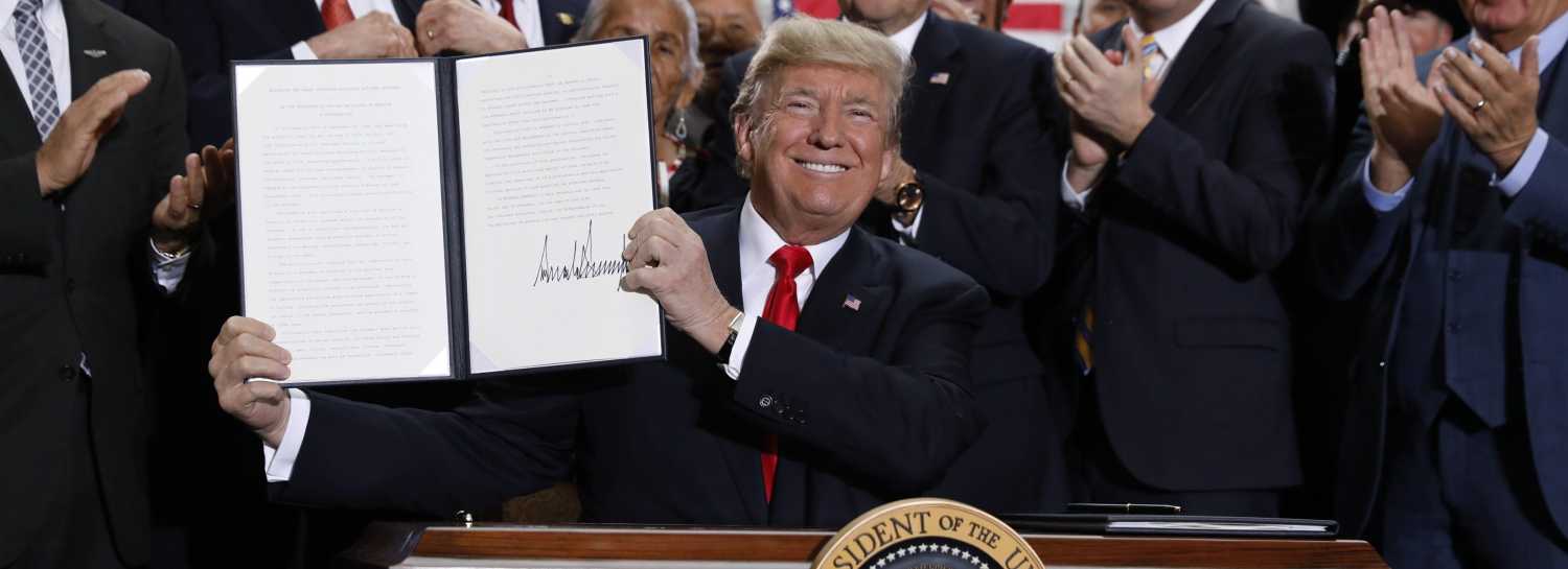 U.S. President Donald Trump displays an executive order after announcing big cuts to Utah's sprawling wilderness national monuments, at the Utah State Capitol in Salt Lake City, Utah, U.S., December 4, 2017. REUTERS/Kevin Lamarque - HP1EDC41JH3C7