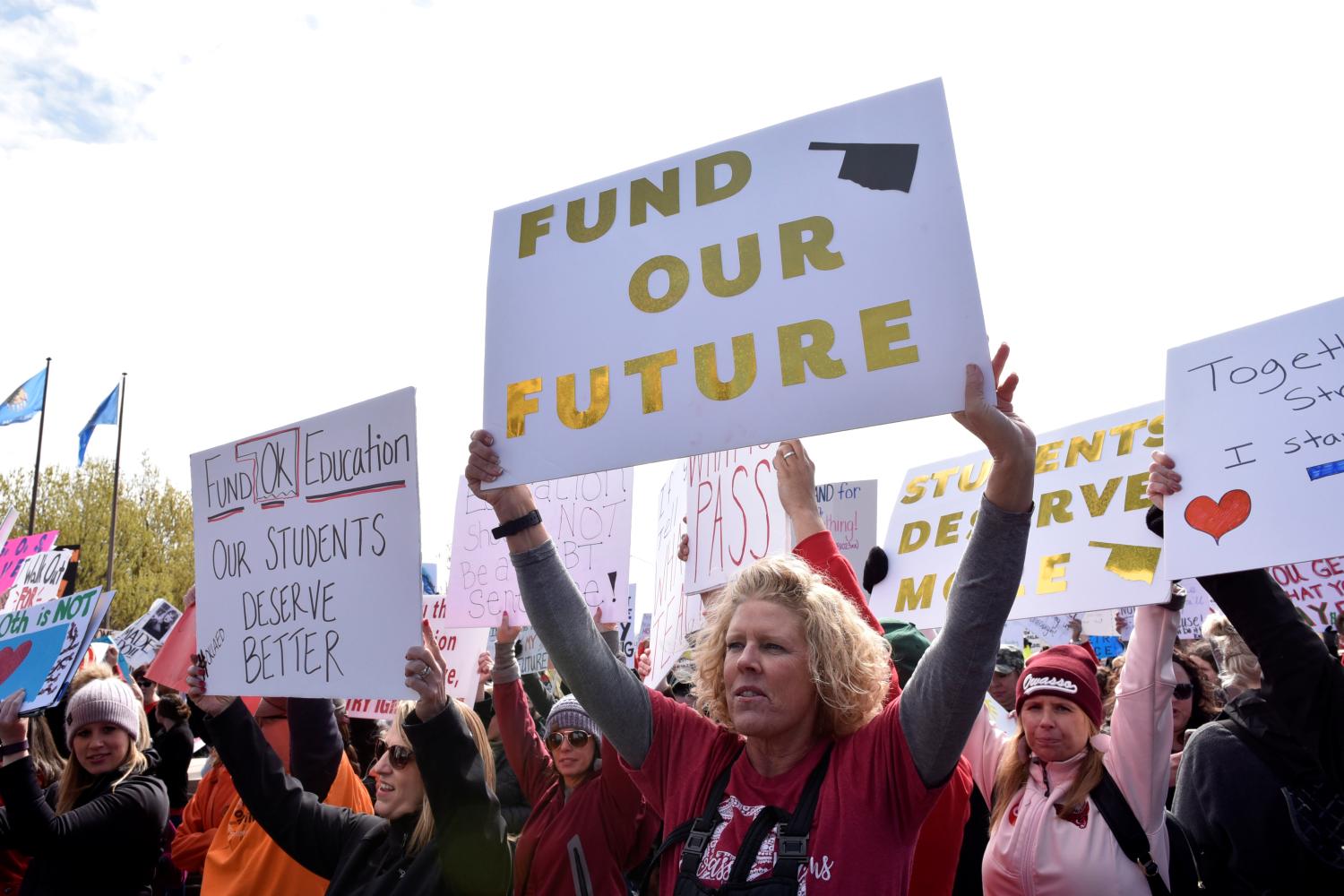 Teachers rally outside the state Capitol on the second day of a teacher walkout to demand higher pay and more funding for education in Oklahoma City, Oklahoma, U.S., April 3, 2018.  REUTERS/Nick Oxford - RC1DB35DAD60