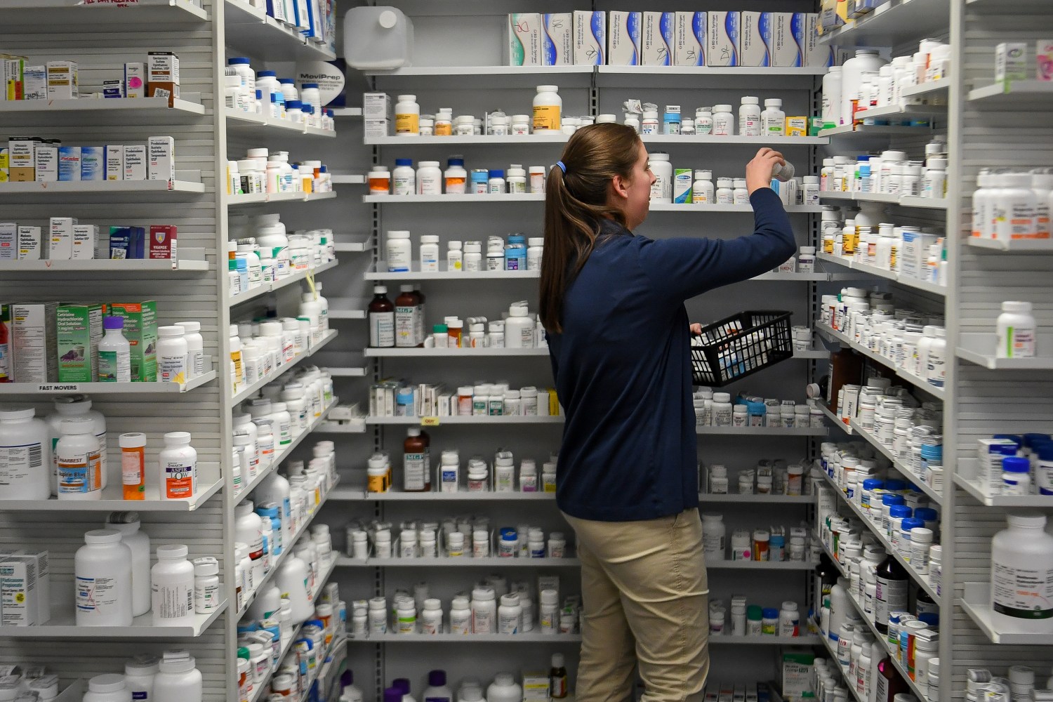 A technician stocks the shelves of the pharmacy at White House Clinic in Berea, Kentucky, U.S., February 7, 2018. Picture taken February 7, 2018. REUTERS/Bryan Woolston - RC19281A85B0