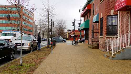 Pedestrian pass shuttered buildings in Ward 8 in Washington DC.