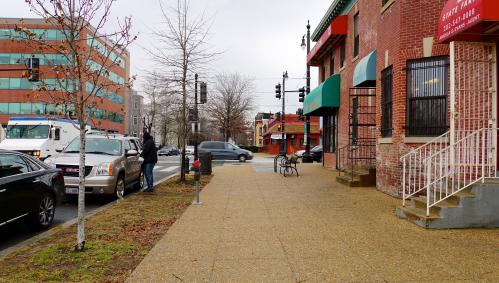 Pedestrian pass shuttered buildings in Ward 8 in Washington DC.