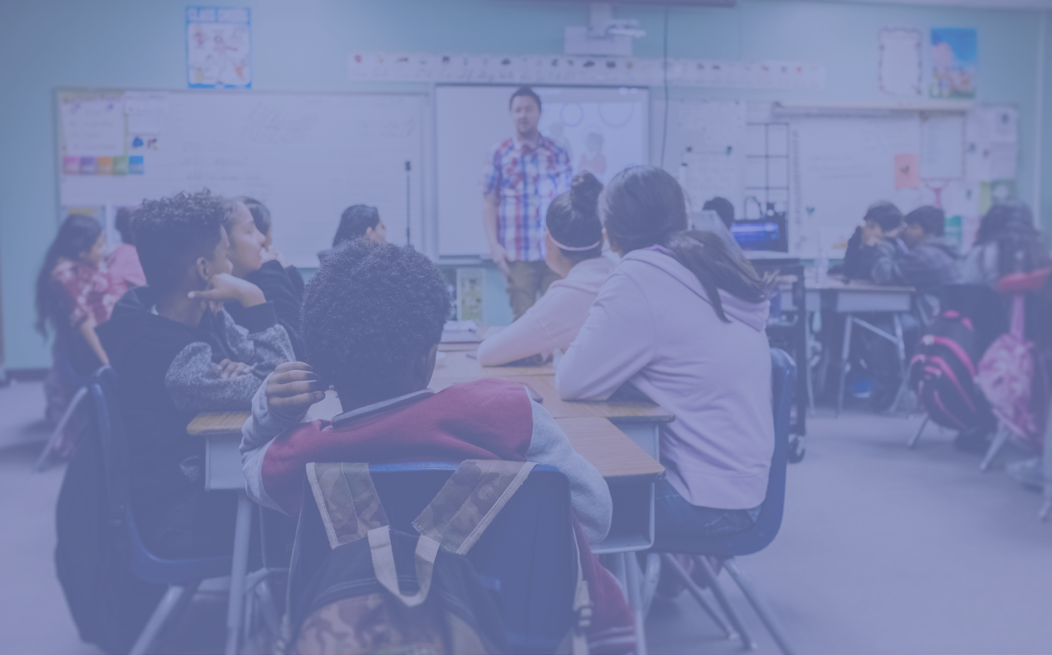 Teacher standing in class in front of students