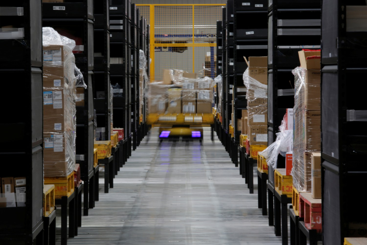 A robot moves goods through stocking shelves