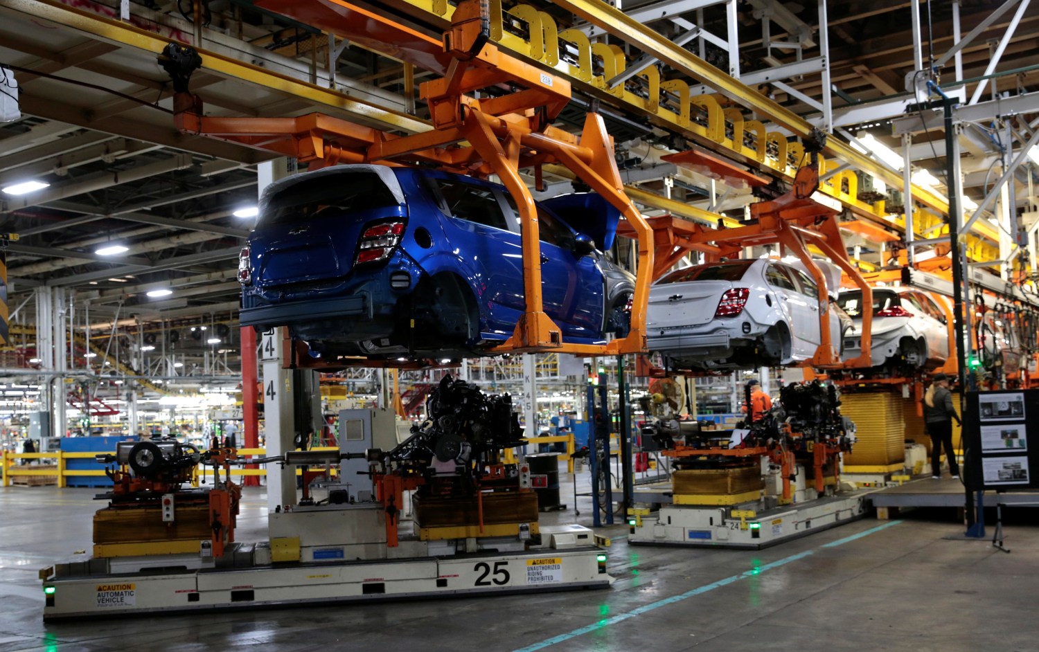 Automated Guided Vehicles carry the chassis for 2018 Chevrolet Sonic vehicles on the assembly line at General Motors Orion Assembly in Lake Orion, Michigan, U.S., March 19, 2018.  Photo taken March 19, 2018.   REUTERS/Rebecca Cook - RC1ED1C67090
