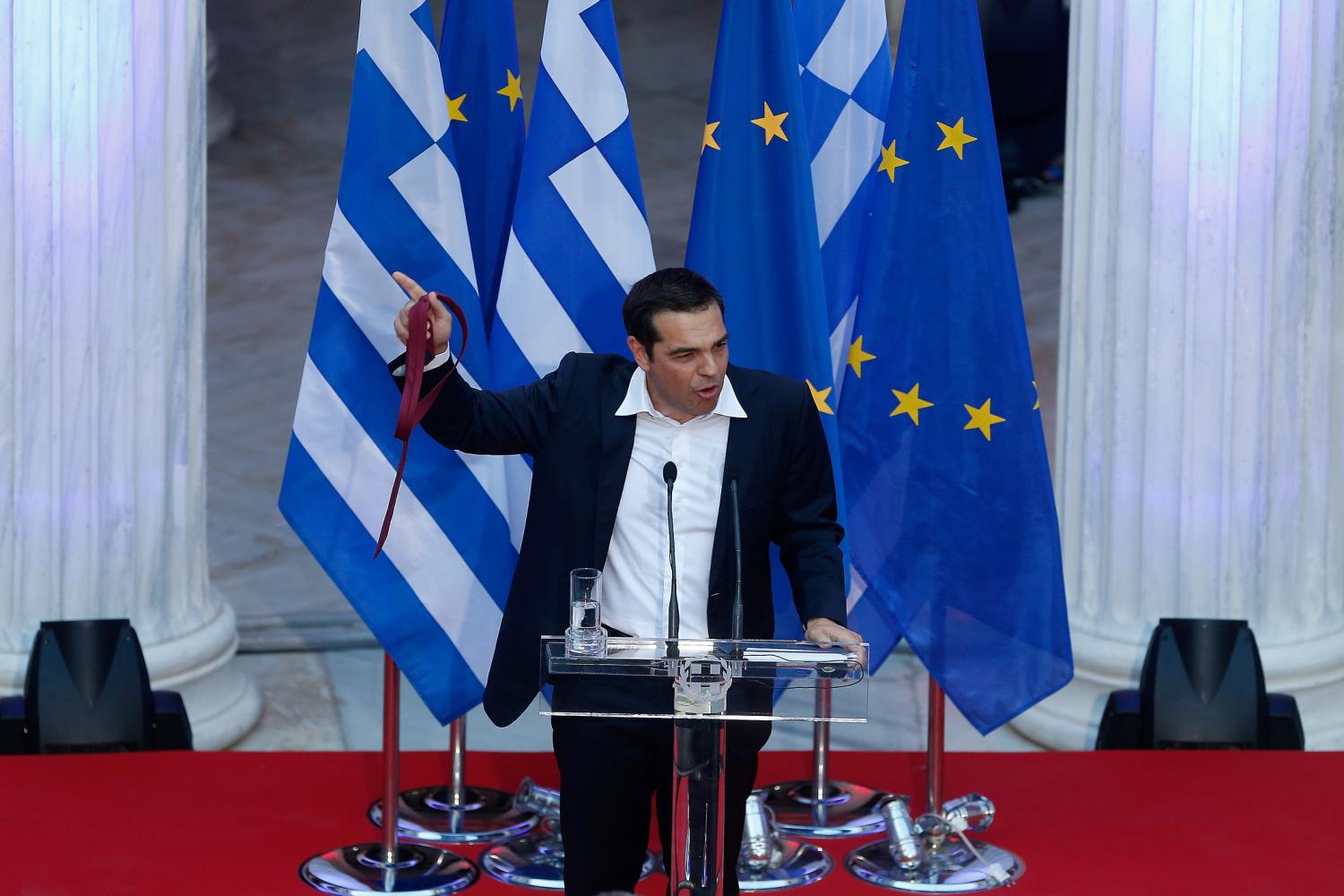 Greek Prime Minister Alexis Tsipras holds his tie as he speaks at the parliamentary group of Syriza and Independent Greeks in Athens, Greece, June 22, 2018.REUTERS/Costas Baltas - RC1866D1E820