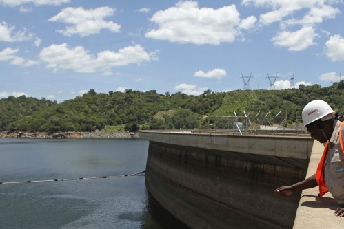 An official of the Zimbabwe Electricity Supply Authourity (ZESA) inspects water levels on the Kariba dam in Kariba, Zimbabwe, February 19, 2016. REUTERS/Philimon Bulawayo - GF10000315340