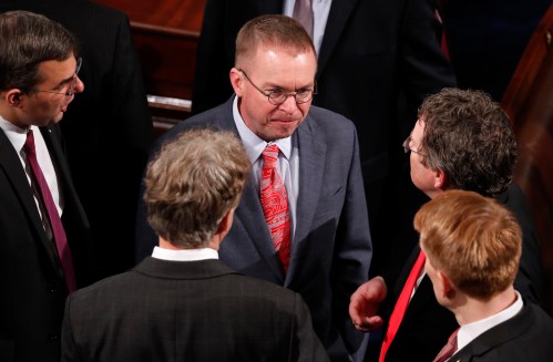 Office of Management and Budget Director Mick Mulvaney talks with members of Congress during President Donald Trump's State of the Union address to a joint session of the U.S. Congress on Capitol Hill in Washington, U.S. January 30, 2018. REUTERS/Jonathan Ernst - HP1EE1V08D9WD